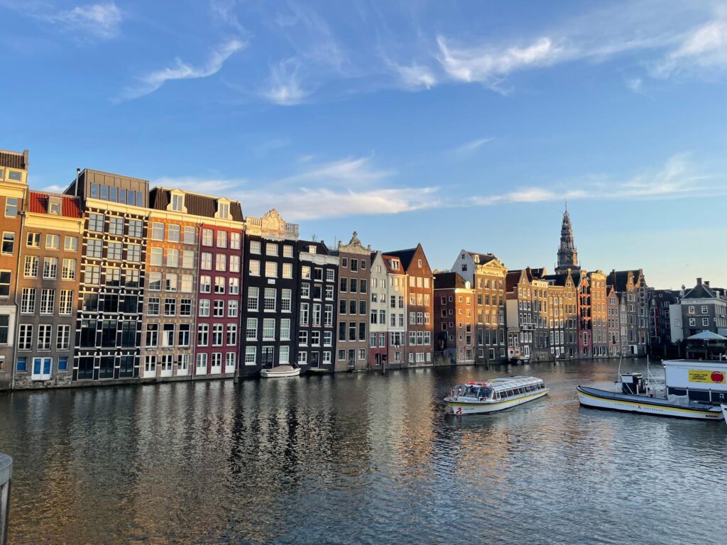 Damrak canal houses in Amsterdam during a private walking tour